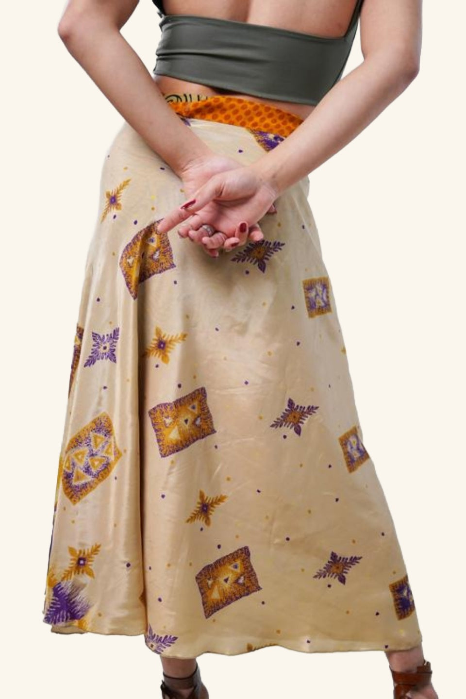Model showing backside of long wrap skirt with geometric and floral patterns