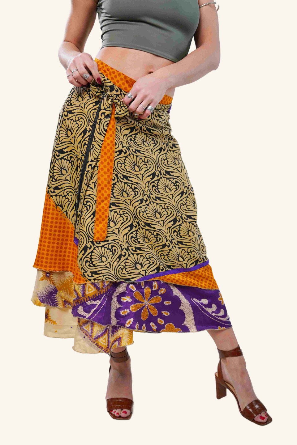 Model wearing long wrap skirt with bold leaf motif