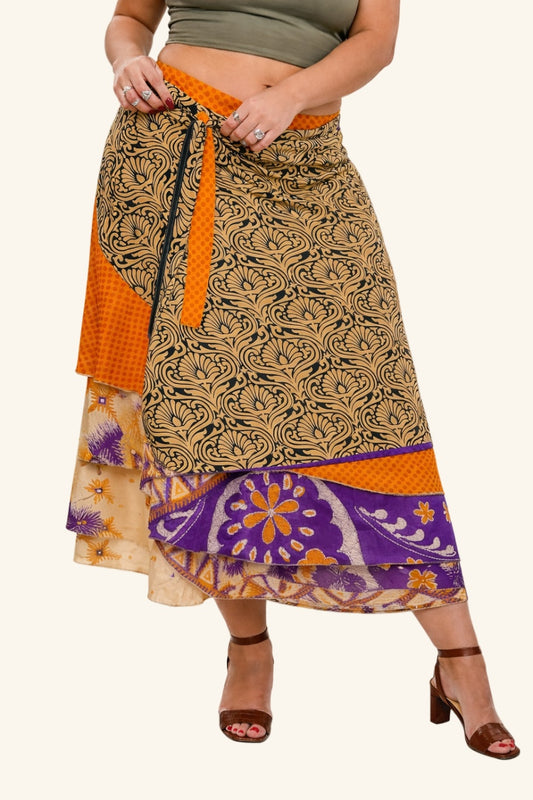 Model wearing long wrap skirt with bold leaf motif