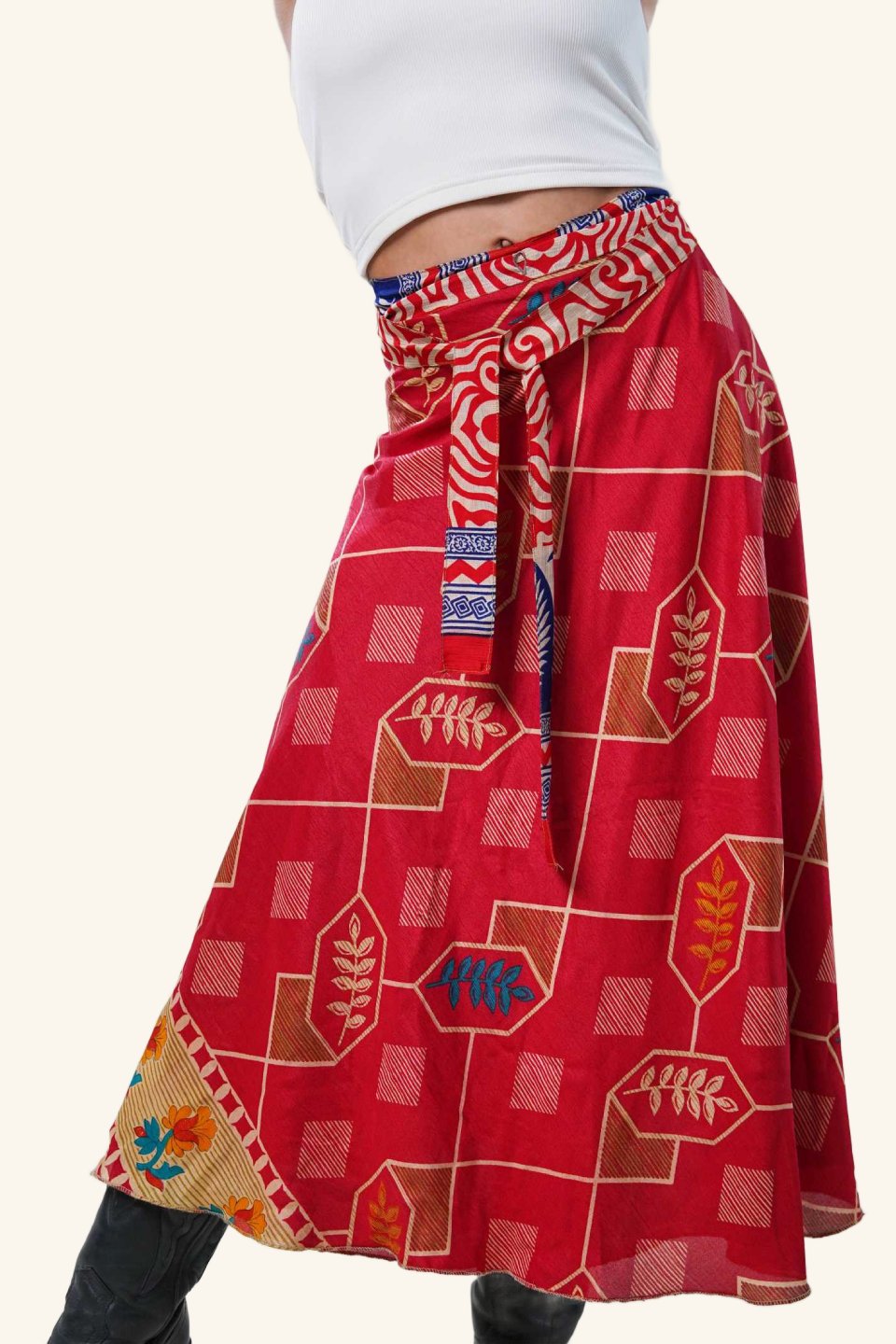 Model wearing long wrap skirt with geometric and leaf patterns
