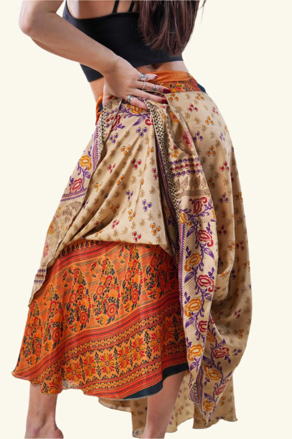 Model showing reversibility feature of long wrap skirt with beige paisley design