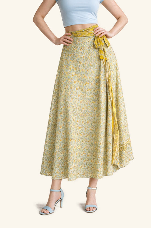 Woman wearing a yellow floral skirt with a white background