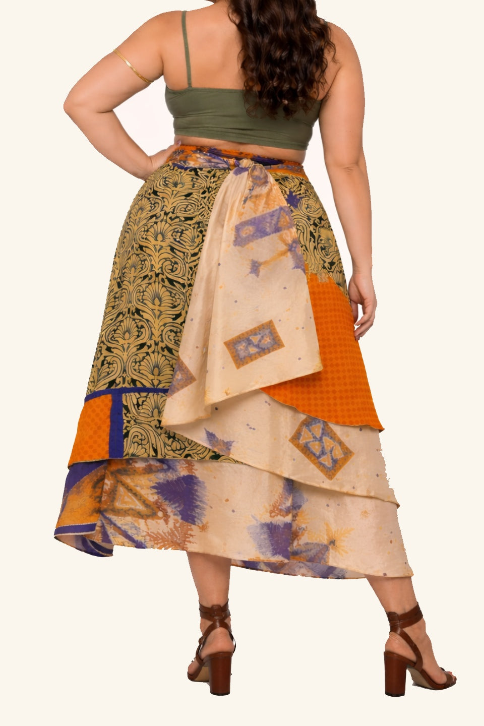 Backside of long wrap skirt with bold leaf motif on model