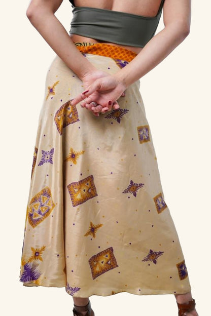 Model showing backside of long wrap skirt with geometric and floral patterns