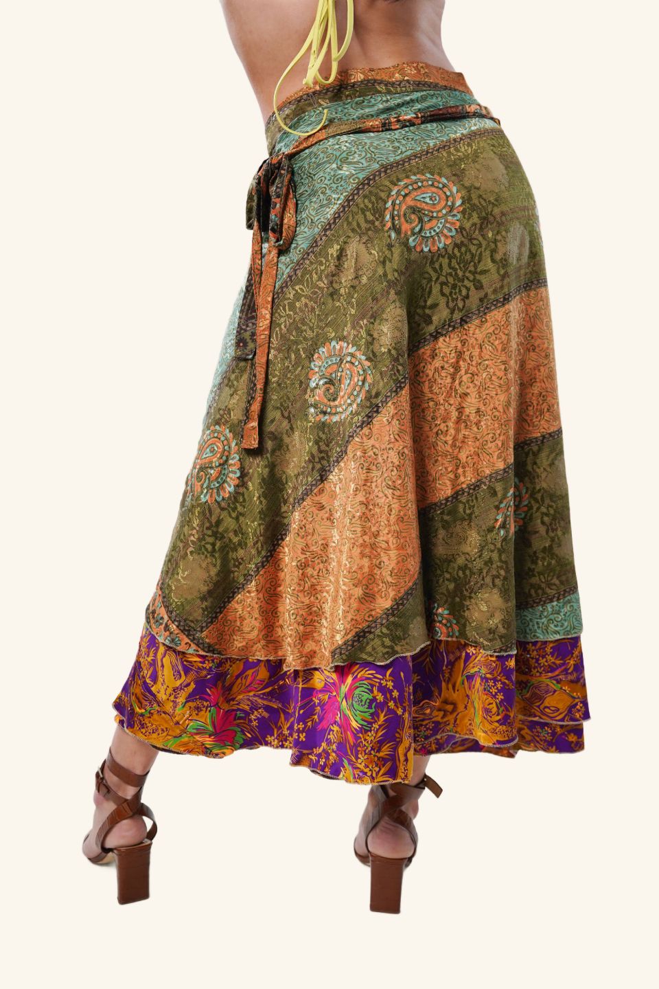 Model wearing long wrap skirt with paisley design from the backside