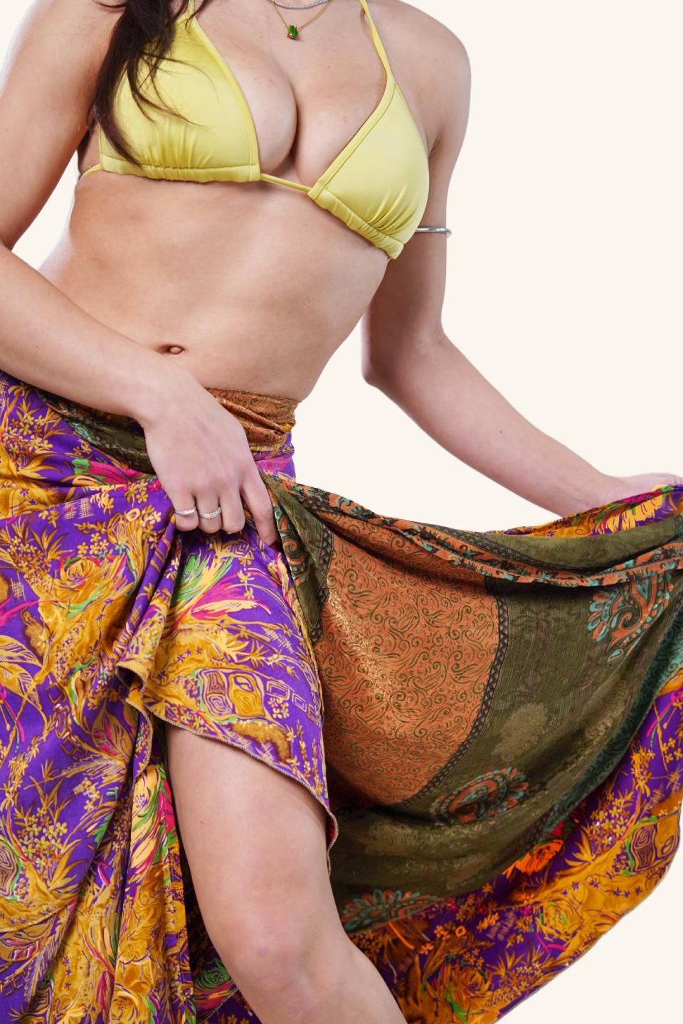 Model showing the reversibility feature of the long wrap skirt