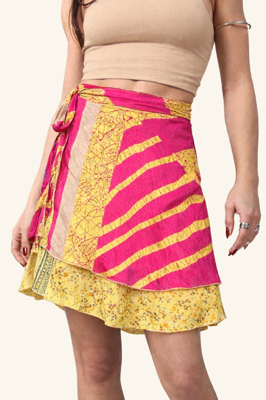 Woman wearing a yellow and pink patterned skirt on a plain background