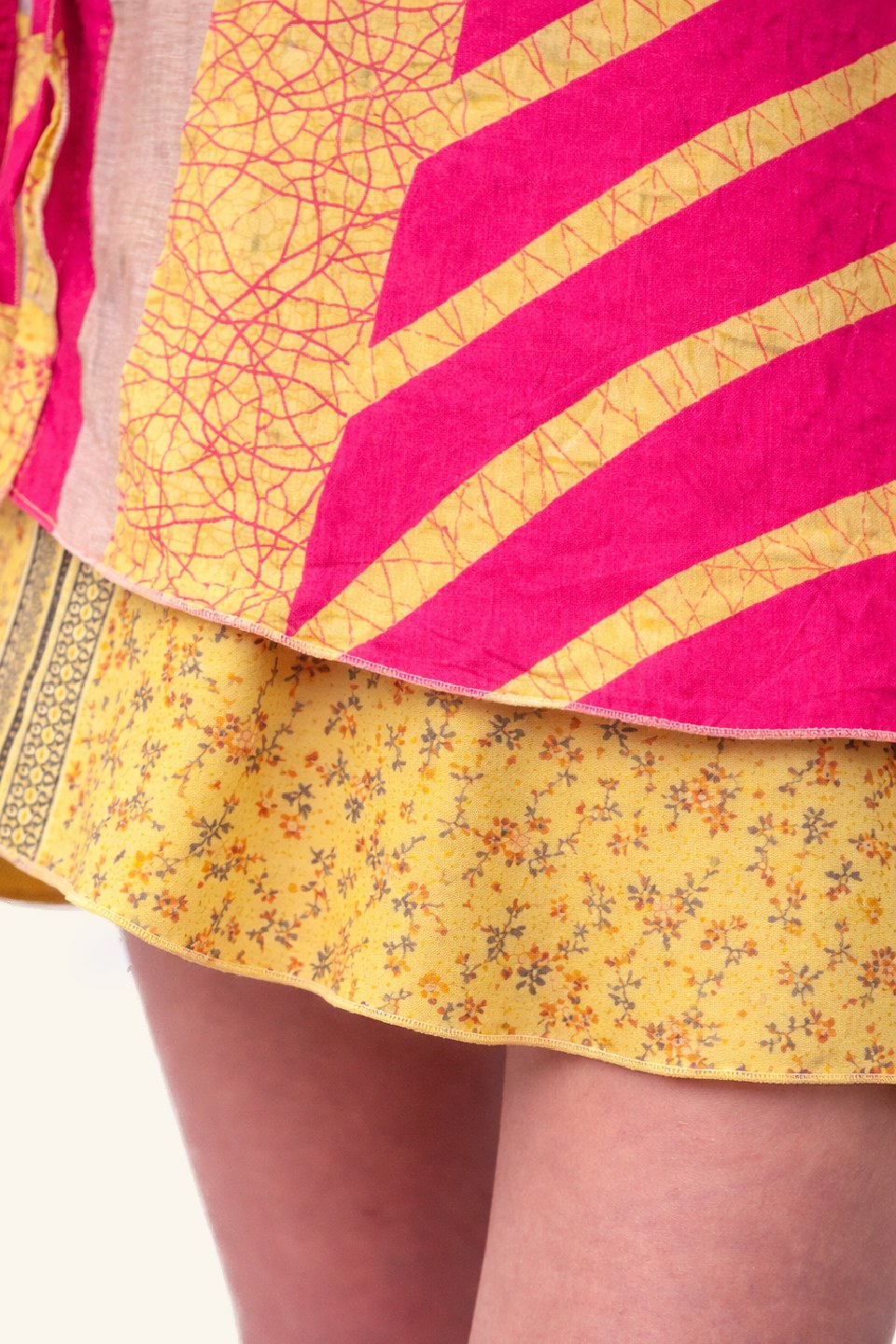 Close-up of a yellow floral skirt with pink and gold patterned top
