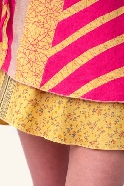 Close-up of a yellow floral skirt with pink and gold patterned top