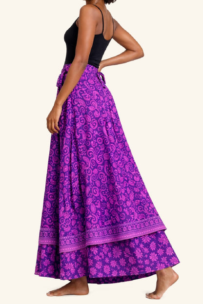 Purple patterned skirt worn by a person on a beige background